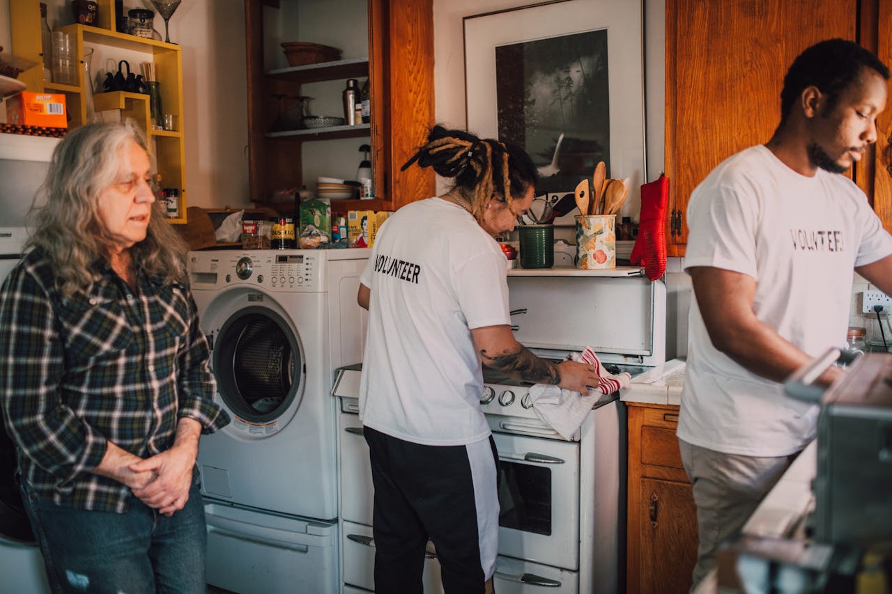 about-us Volunteers preparing food in a community kitchen to support local charity efforts.